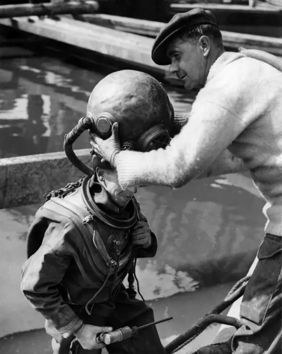 Framed Print : Diver Jack Ellis having his helmet put on. September 1949