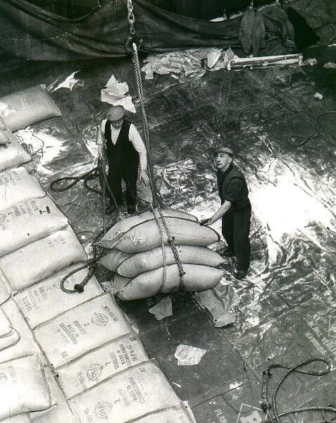 Dockers unloading a cargo of sugar. circa 1960
