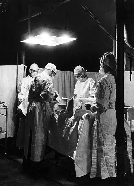 Doctors at work in the operating theatre of a field hospital in Normandy during WW2