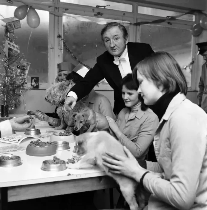 Framed Print : Dog Owners and their pets seen here having a Christmas party as actor Ronald Fraser acts Framed Print : Dog Owners and their pets seen here having a Christmas party as actor Ronald Fraser acts