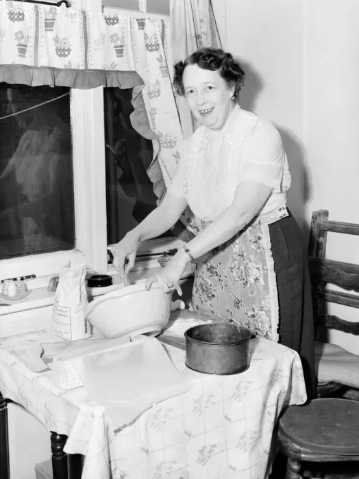 Framed Print : Domestic scenes: A woman making cakes in her kitchen at home. 1954 Framed Print : Domestic scenes: A woman making cakes in her kitchen at home. 1954