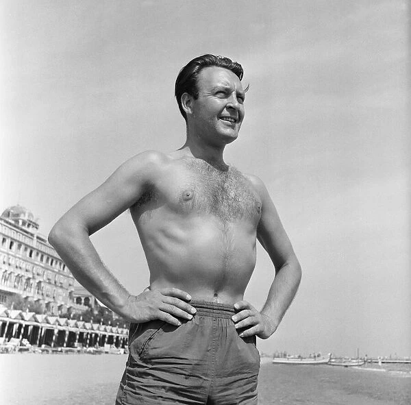Donald Sinden seen here on the beach during the Venice Film Festival. 8th September 1955