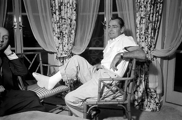 Donald Zec with film star Alan Ladd, who has injured his foot. October 1953 D6473
