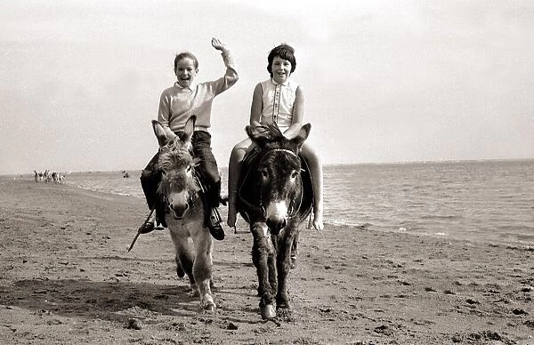 Donkey rides on Exmouth Beach children childhood Holidaymakers