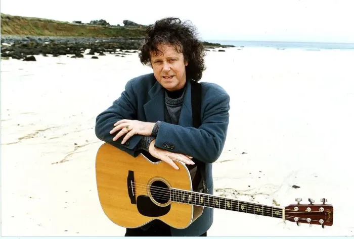Framed Print : Donovan Pop Star of the 60s pictured at a beach with his guitar hanging around his neck