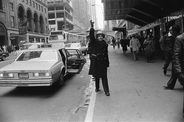 A doorman hailing a cab in New York, 13th February 1981