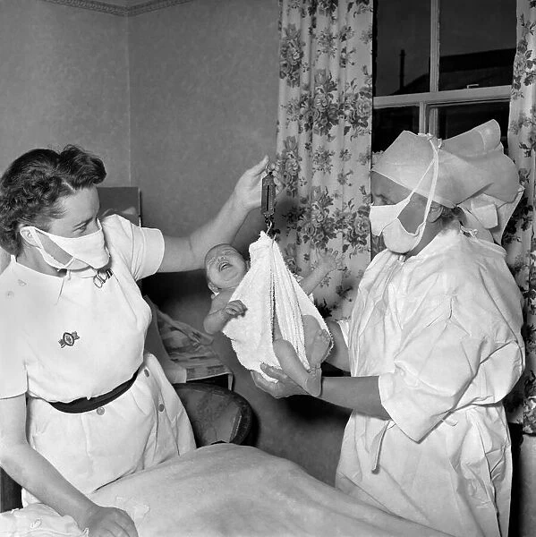 Dorathy Anderson seen here delivering a baby at the Stretham Clinic. August 1953 D5187