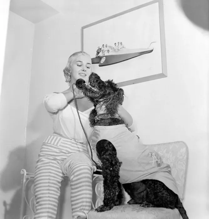 Framed Print : Dory Swan and her pet dog talking on the telephone Circa 1955 Framed Print : Dory Swan and her pet dog talking on the telephone Circa 1955