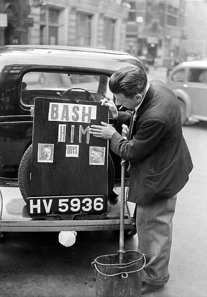 A driver pastes a picture of Hitler and the words Bash Him on to the boot of his car
