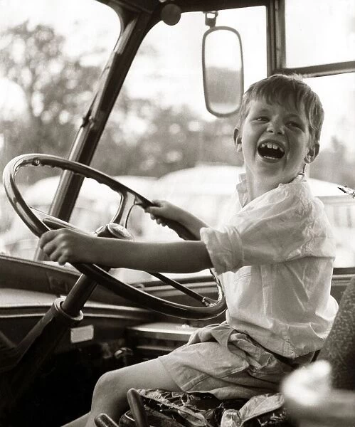 In the driving seat - John Curry aged 6 behind the wheel of a coach, August 1959