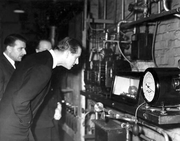 Duke of Edinburgh looking, with Mr. A. Parker (in glasses) Director of Fuel Research