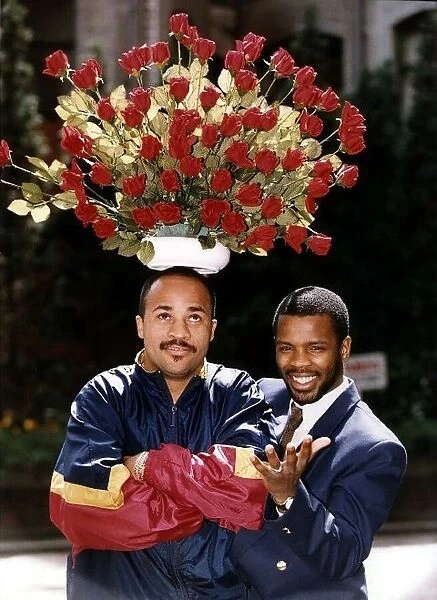Duke McKenzie Boxing WBO Bantamweight champion holds a flower pot full of red roses