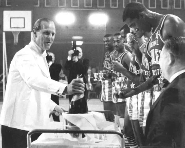 Framed Print : The Duke pours champagne for the Globe Trotters: The Duke of Edinburgh pours for members