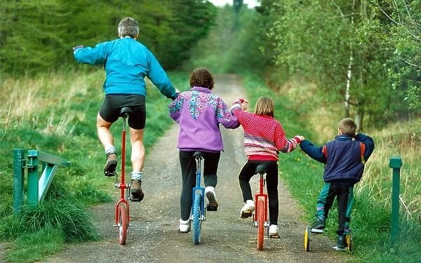 Duncan, Christine, Lisa and Adam on their unicycles near their home in High Spen