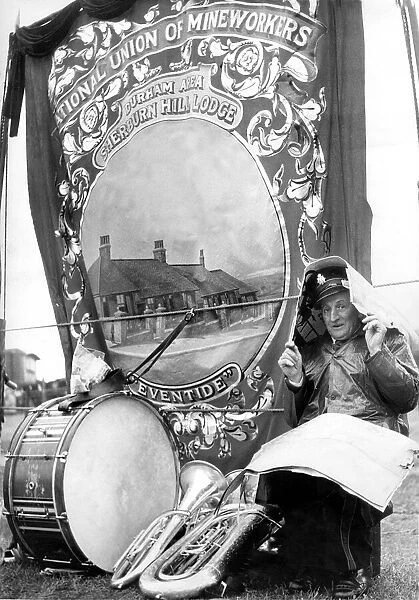 Durham Miners Gala - John Nicholson, a bandsman, shelters from the weather