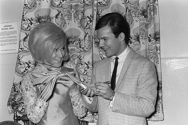 Dusty Springfield with pop singer Bobby Vee March 1964 exchange autographs during