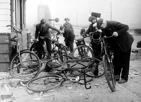 Dutch civilians select bikes left by German soldiers at the end of the Waal Bridge