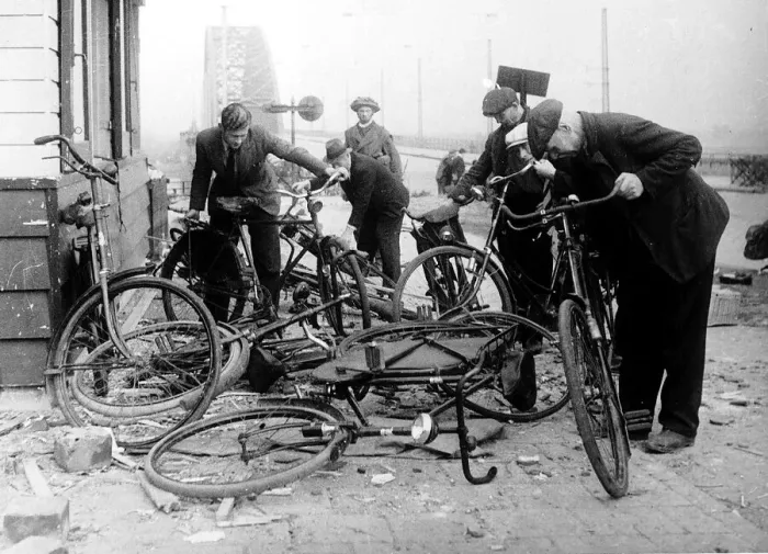 Framed Print : Dutch civilians select bikes left by German soldiers at the end of the Waal Bridge Framed Print : Dutch civilians select bikes left by German soldiers at the end of the Waal Bridge