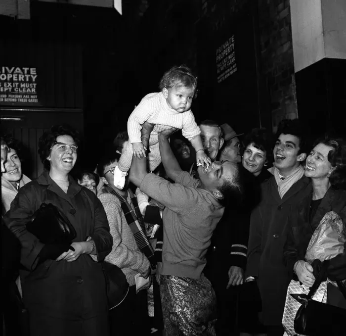 Framed Print : Eartha Kitt with her baby daughter Kitt meeting fans outside the stage door after a dress Framed Print : Eartha Kitt with her baby daughter Kitt meeting fans outside the stage door after a dress