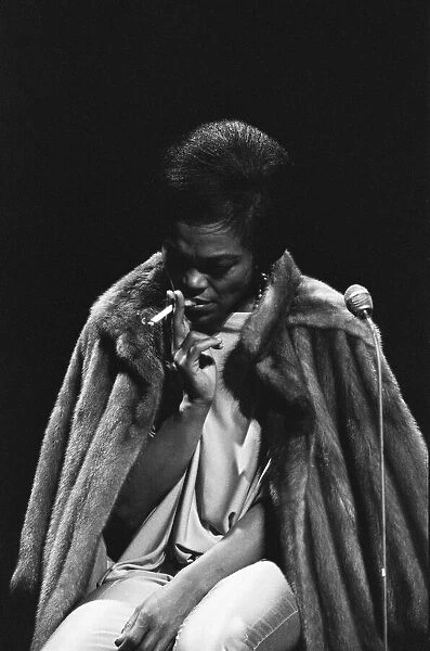 Eartha Kitt smoking a cigarette on stage during Royal Command Performance rehearsals