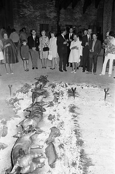 Eating Out, Majorca, Spain, August 1971. Pigs being roasted on spit