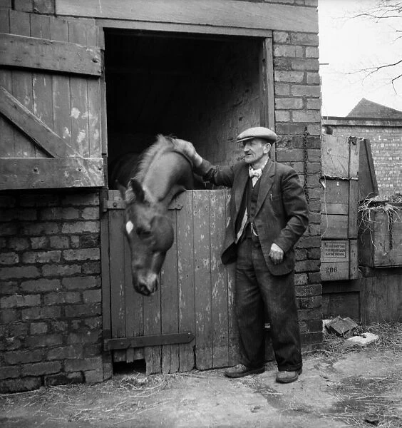 Eccentric millionaire Bob Hiddle patting his horse at his stable