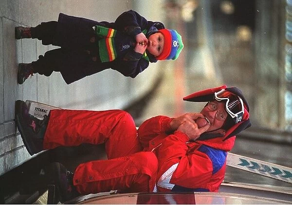Eddie Edwards in red ski suit, Eddie the Eagle Edwards making friends with 2 year old