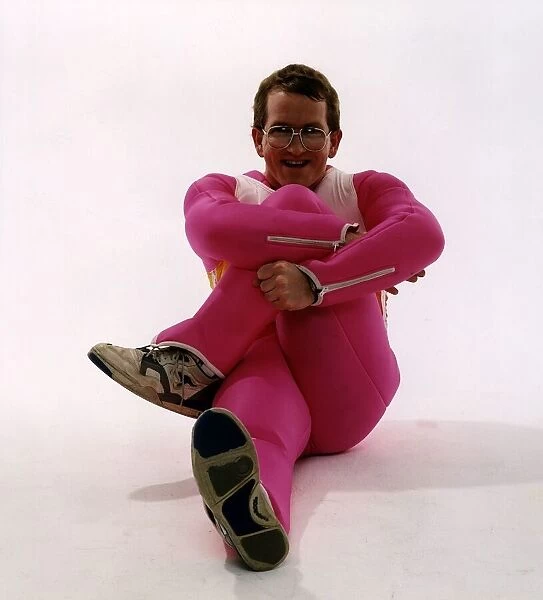 Eddie Edwards ski jumper sitting in pink ski suit