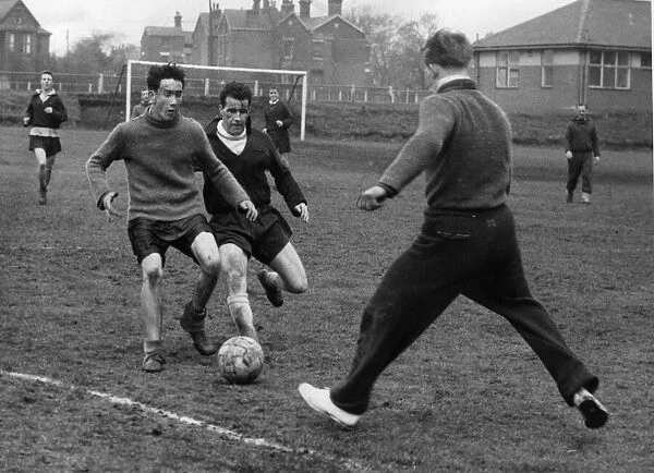 Eddie Hopkinson Bolton Wanderers goalkeeper (right) clears the ball during a training