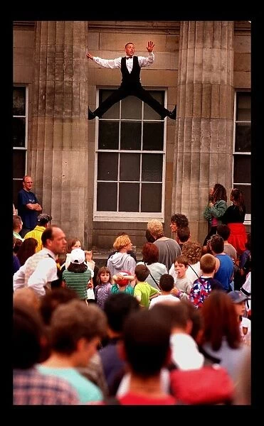 Edinburgh Festival August 1998 man performer climbing up between two pillars
