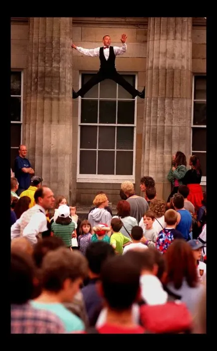 Framed Print : Edinburgh Festival August 1998 man performer climbing up between two pillars Framed Print : Edinburgh Festival August 1998 man performer climbing up between two pillars