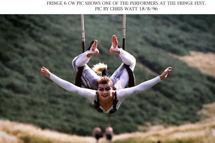 Framed Print : Edinburgh Fringe Festival performer acrobat hanging onto swing with legs arms Framed Print : Edinburgh Fringe Festival performer acrobat hanging onto swing with legs arms