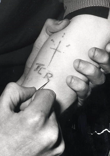 Edinburgh gangs January 1973 a teenager with his sleeve rolled up getting tattoed