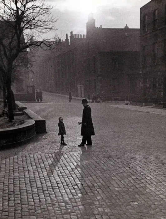 Framed Print : Edinburgh street scenes Policeman talking to lost child on a cobbled street in Framed Print : Edinburgh street scenes Policeman talking to lost child on a cobbled street in