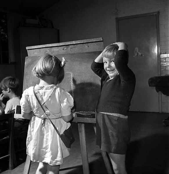 Education: Nursery School: Children: A boy and girl seen here painting at the Barley Park