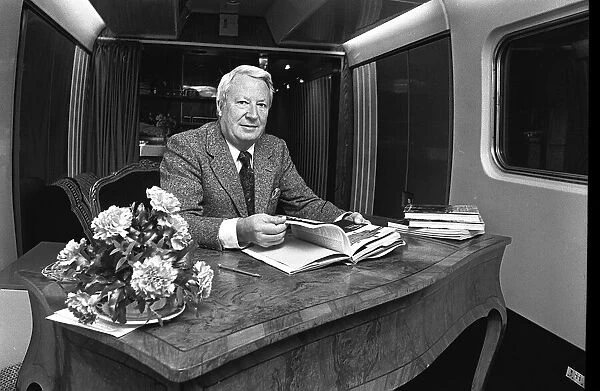 Edward Heath onboard a train at Moor Street Station signing copies of his latest books