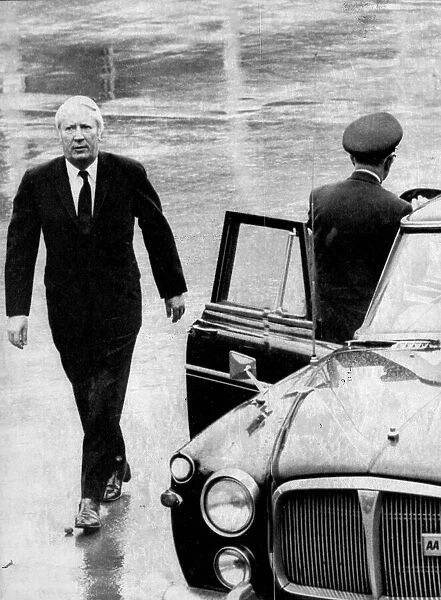 Edward Heath walking in the rain to official car - December 1972