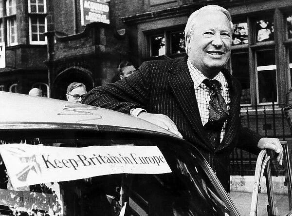 Edward Ted Heath about to get into his car which has a sticker on it saying KEEP BRITAIN