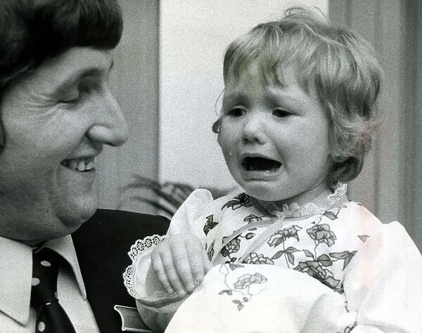 Eighteen month old Clare Timewall held by her father Chris crying her eyes out after