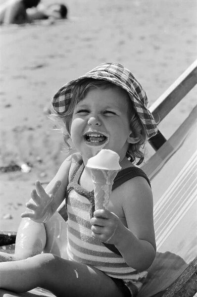 Eighteen month old Nicola England from Bromley, Kent enjoys an ice cream on the beach at