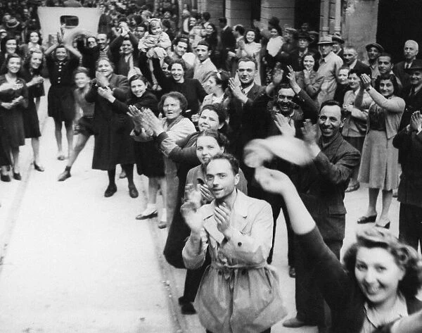 Eighth Army troops enter Bologna. (Picture) Cheering crowds gather in thousands to