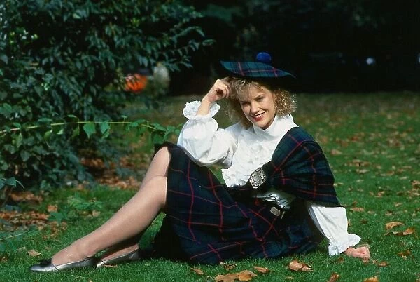 Elaine Smith actress sitting on grass wearing kilt and hat