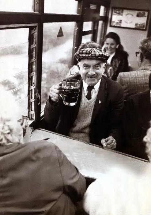Framed Print : An elderley man enjoying a pint of beer on a Ffestiniog Railway train in North Wales