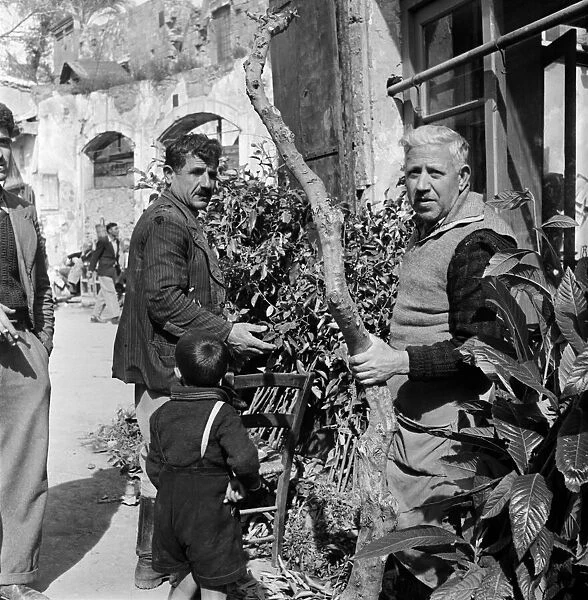 Elderly local men chatting on the street in a Cyprus town. March 1952 C1297-002