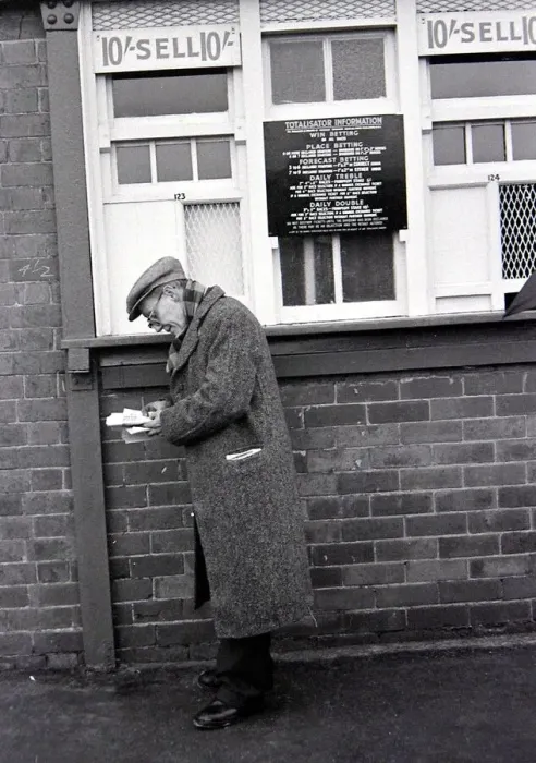 Framed Print : An elderly man holding his receipts after placing a bet on the tote before a race Framed Print : An elderly man holding his receipts after placing a bet on the tote before a race