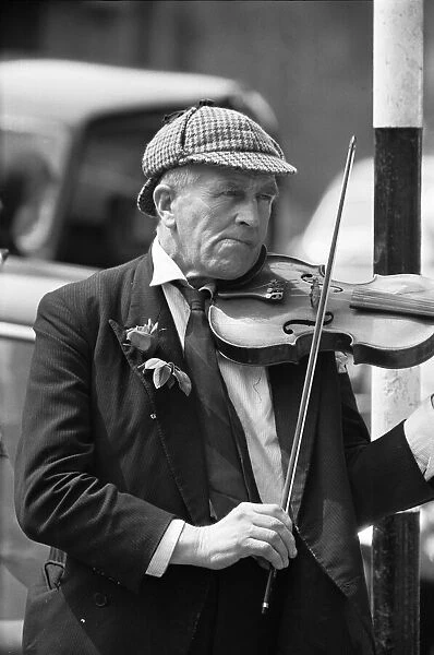 Elderly street musician performing on the streets of central London