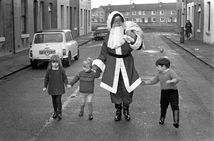Framed Print : An elderly woman dressed as Santa Claus on her way to an engagement accompanied by