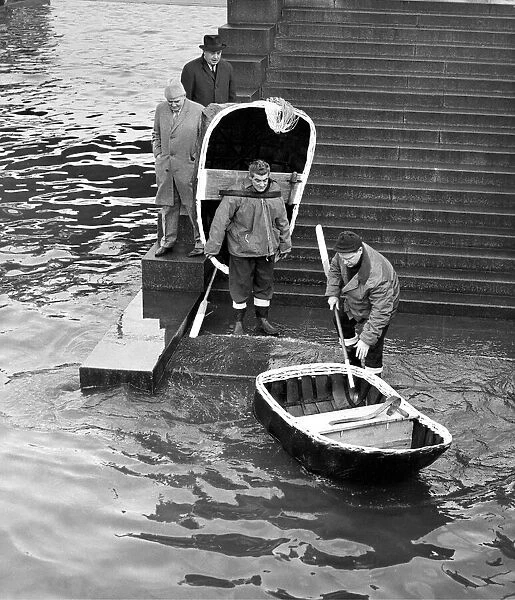 The Elias brothers putting their coracles into the River Thames at Festival Pier for a