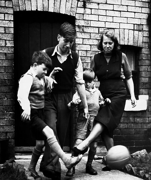 Elizabeth Charlton playing a game of football with her three sons Gordon aged 10
