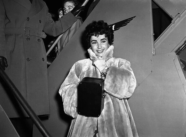 Elizabeth Taylor on arrival at the London Airport with Michael Wilding February